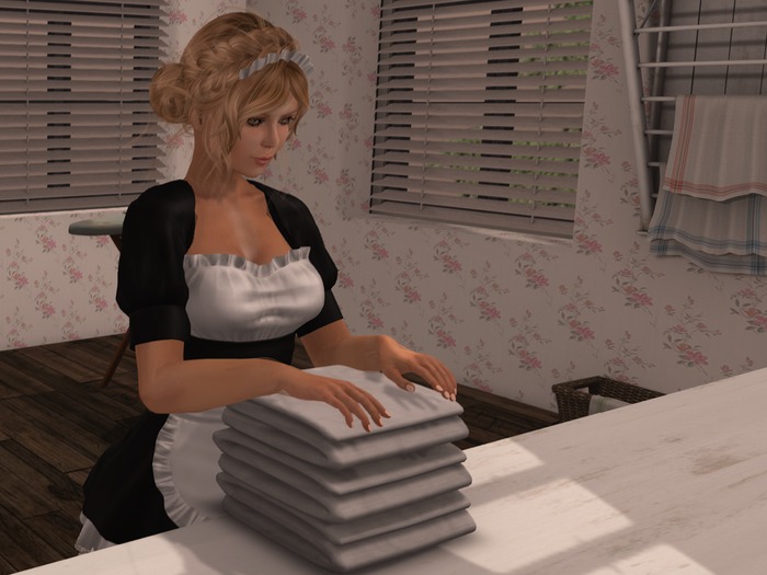 maid folding the laundry